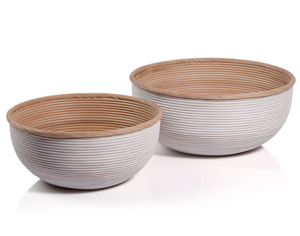 The Santo Rattan Bowl Collection by Zodax features two round ribbed rattan bowls with light wood interiors and white exteriors, one large and one small—an elegant artisanal accent for your space.