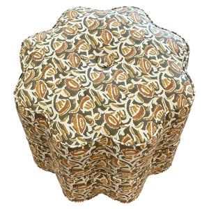 The Bunny Williams Stella Stool features scalloped edges and is upholstered in a patterned fabric with brown, beige, and olive green leaf designs—ideal as a stylish foot rest.