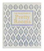 A white book cover titled "The Principles of Pretty Rooms" by Graphic Image features a blue and gold patterned design—an inspiring guide for fans of beautiful, timeless interiors.