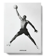 Black and white image of a shirtless basketball player, Air Jordan style, leaping with one arm outstretched holding a basketball; "Assouline" appears at the bottom.