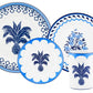 A set of blue and white porcelain dishes and a mug from the Aquazzura Casa Jaipur Blue Dinnerware Collection, featuring handcrafted palm tree and floral designs.