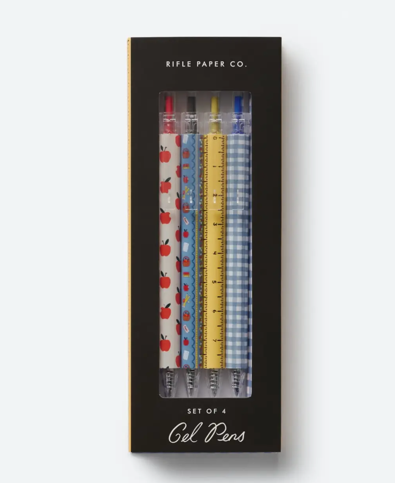 A boxed set of four gel pens from the Rifle Paper Co. Schoolhouse Collection, featuring playful designs—apples, flowers, ruler markings, and blue gingham. A charming addition to your desk supplies or a thoughtful teacher gift inspired by classic schoolhouse style.