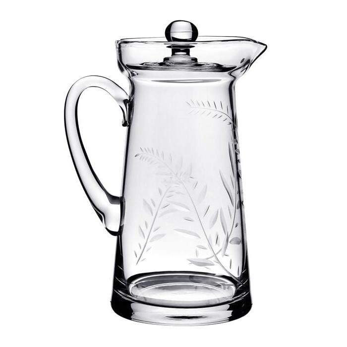 The Jasmine Pitcher Collection by William Yeoward Crystal features a clear glass pitcher with handle and lid, adorned with an elegant leaf and branch etching reminiscent of a cherished wedding gift or jasmine’s delicate beauty.