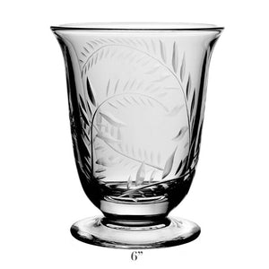 The Jasmine Flower Vase Collection by William Yeoward Crystal features a handmade clear glass vase with etched leaf and jasmine vine motifs, flared rim, round base, and stands 6 inches tall.