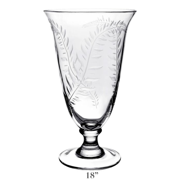 The Jasmine Flower Vase Collection by William Yeoward Crystal features an 18-inch clear glass vase with a pedestal base, etched fern leaf and subtle jasmine vine designs, adding handmade elegance to your décor.