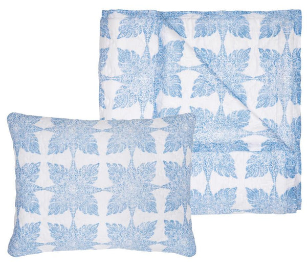 The John Robshaw Jaya Azure Bedding Collection, on final sale, includes a white pillow and blanket set adorned with blue floral patterns. Crafted from soft cotton voile, it showcases unique hand-printed designs for a distinctive touch.