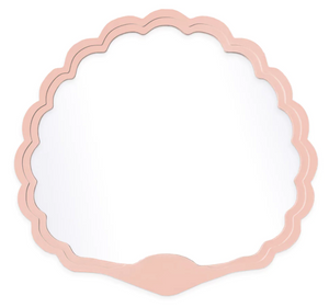 The Carnival Proteus Mirror by Fleur Home features a scallop shell shape, pink frame, and curved edges—perfect for adding Mardi Gras Krewe flair to any New Orleans-inspired space. Photographed against a white background.