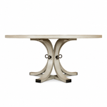 The Artisan Round Dining Table by Hickory Chair is crafted from light-toned wood and features a sculptural pedestal base with curved, intersecting legs joined by metal rings, shown against a plain white background.