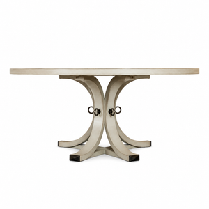 The Artisan Round Dining Table by Hickory Chair is crafted from light-toned wood and features a sculptural pedestal base with curved, intersecting legs joined by metal rings, shown against a plain white background.