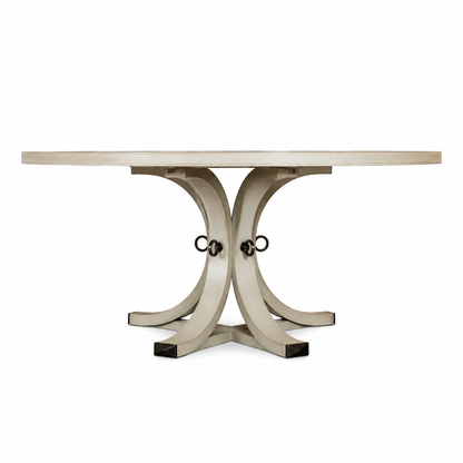 The Artisan Round Dining Table by Hickory Chair is crafted from light-toned wood and features a sculptural pedestal base with curved, intersecting legs joined by metal rings, shown against a plain white background.