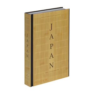 Japan: The Cookbook" by Phaidon is a hardcover featuring authentic Japanese recipes, a gold cover, and line patterns.