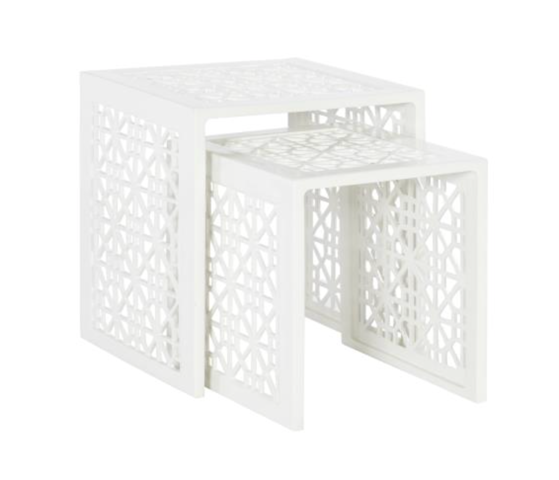 The Haret Outdoor Nesting Table by Hickory Chair features two white cast aluminum tables with geometric cut-out patterns, designed to nest together—ideal for any outdoor collection.