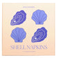 Square box packaging for Piecework Shell Cocktail Napkins featuring four purple shell illustrations and text reading “Shell Napkins 4 Cocktail Napkins.”