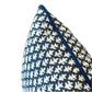 Close-up of the Burma Indigo Outdoor Lumbar Pillow by Associated Design, featuring a blue and white geometric pattern with blue edging, crafted from premium materials and displayed on a white background.