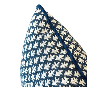 Close-up of the Burma Indigo Outdoor Lumbar Pillow by Associated Design, featuring a blue and white geometric pattern with blue edging, crafted from premium materials and displayed on a white background.
