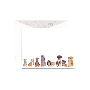 The Dog Group Folded Card Set by Crane features eight cheerful dogs illustrated along the bottom of a pearl white notecard, paired with a matching envelope.