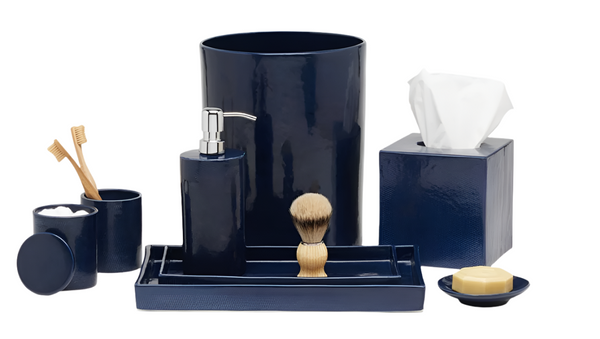 Explore the Pigeon & Poodle Cordoba Navy Bath Collection, a navy blue set featuring navy burlap ceramic items: waste bin, toothbrush holder, soap dispenser, shaving brush, tissue box, soap dish, and small container.