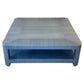 The Series O Custom Cocktail Table by T3 Custom Furniture features an azure finish, rounded corners, and an open lower shelf, showcased against a white background.