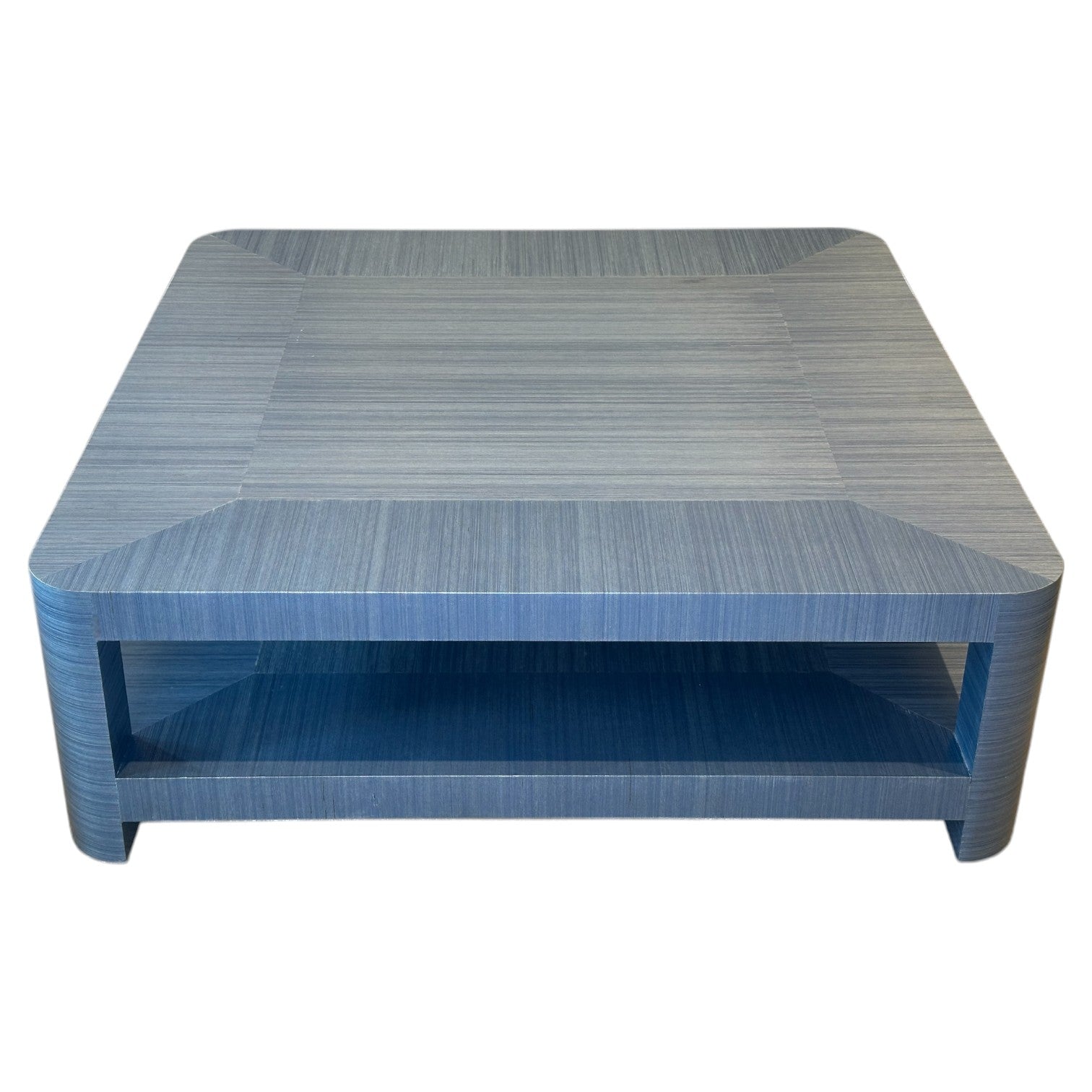 The Series O Custom Cocktail Table by T3 Custom Furniture features an azure finish, rounded corners, and an open lower shelf, showcased against a white background.