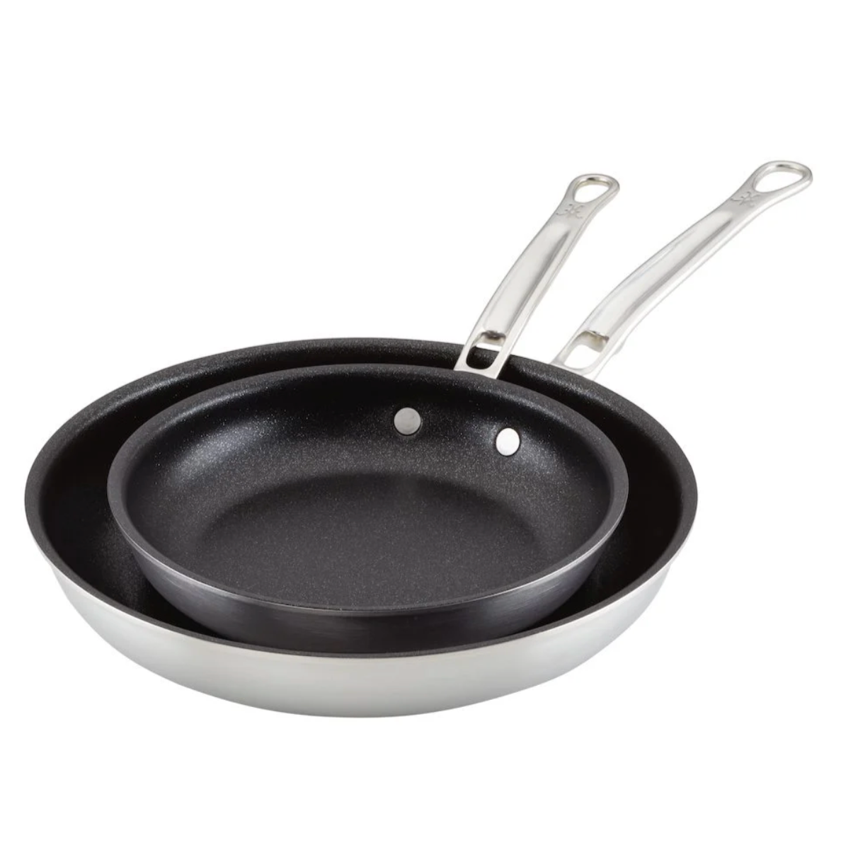 The Hestan Thomas Keller Commercial Clad Stainless Steel TITUM® Nonstick Sauté Pan Set includes two pans, one nested inside the other, both featuring tri-ply clad handles and displayed against a white background.