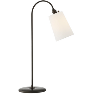 The Mia Table Lamp in Aged Iron by Visual Comfort showcases a curved arm, aged iron finish, and a white cone-shaped shade atop a round base.