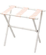 The Sorella Glenn White Luggage Rack, Fern Peachy Pink, features a white maple frame and three pink patterned fabric straps for stylish, functional suitcase storage.