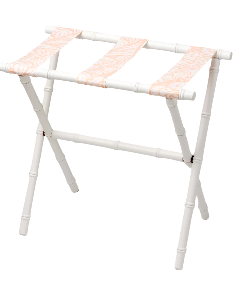 The Sorella Glenn White Luggage Rack, Fern Peachy Pink, features a white maple frame and three pink patterned fabric straps for stylish, functional suitcase storage.