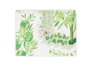 A folded white linen cloth from Matouk's Citrus Garden Grass Collection featuring a green botanical print with leaves, flowers, butterfly, and fruit.