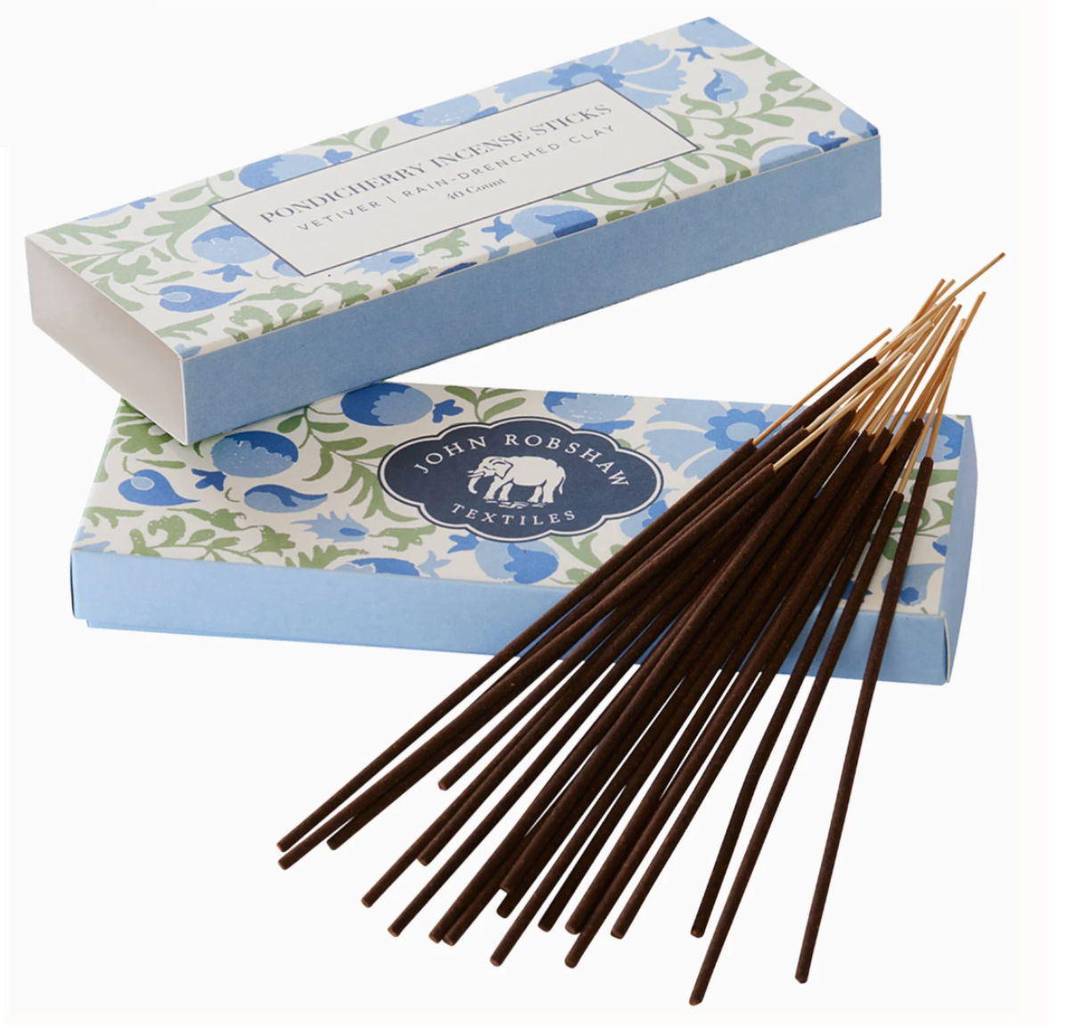 Two blue floral patterned boxes of John Robshaw Pondicherry Candle & Incense Collection incense sticks, with one box open and a cluster of vetiver incense sticks fanned out in front.