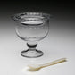 The William Yeoward Crystal Katerina Crystal Caviar Server for 2 features a dotted design, pedestal base, clear glass lid, and comes with a small white spoon—perfect for serving caviar in elegant style.