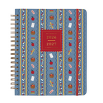 The Rifle Paper Co. Schoolhouse Collection features a blue spiral-bound planner adorned with red and white school-themed designs—apples, pencils, books, scissors—and a red label on the cover that reads “2026 2027 17-Month Planner” in gold text, making it perfect for organizing desk supplies or as a thoughtful teacher gift to brighten any Schoolhouse setting.