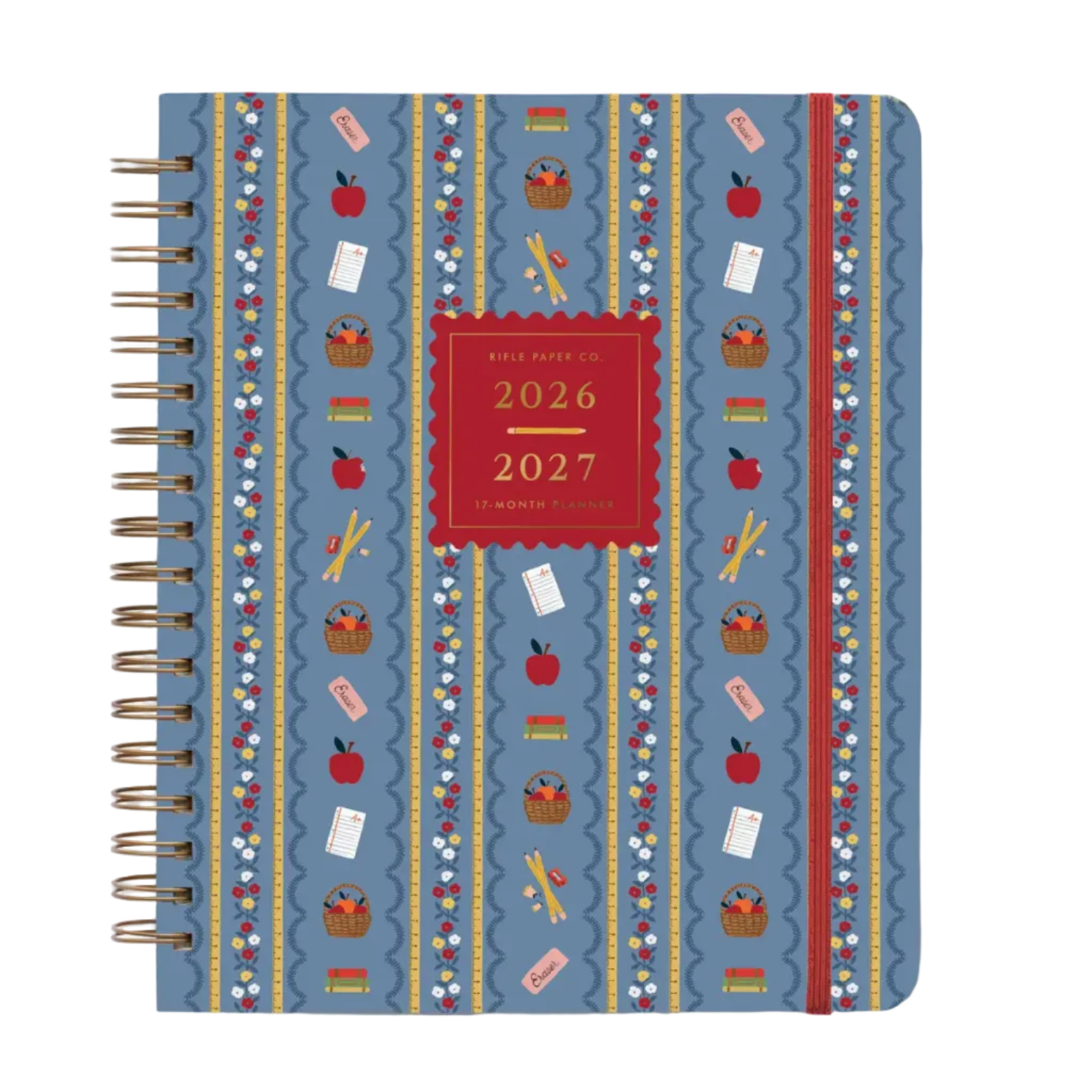 The Rifle Paper Co. Schoolhouse Collection features a blue spiral-bound planner adorned with red and white school-themed designs—apples, pencils, books, scissors—and a red label on the cover that reads “2026 2027 17-Month Planner” in gold text, making it perfect for organizing desk supplies or as a thoughtful teacher gift to brighten any Schoolhouse setting.