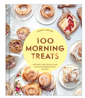 The cover of "100 Morning Treats" by Chronicle Books displays an assortment of pastries and baked goods, ideal for breakfast baking recipes, beautifully arranged on white plates.