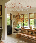 Featuring a bright, welcoming entryway with a wooden bench, potted plant, framed artwork, and an open black door revealing a lush green garden, the cover of A Place To Call Home by Rizzoli showcases the timeless charm that award-winning architect Gil Schafer III brings to inviting home design.
