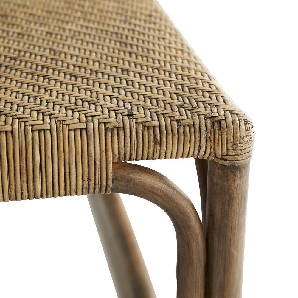 Close-up of the Underhill Coffee Table by Arteriors, featuring a natural wood frame and a woven herringbone rattan pattern that highlights the detailed craftsmanship.