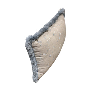 The Klimt Down Lumbar Pillow by Beleo Interiors LLC features a rectangular beige design with small white flowers and blue decorative fringe, displayed at an angle on a white background.