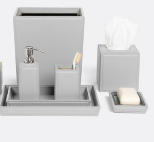 The Rothwell Bath Collection by Pigeon & Poodle is a matching grey set crafted from durable yacht leather and water-resistant materials, including a waste bin, tissue box cover, soap dispenser, toothbrush holder, tray, and soap dish with soap.