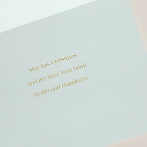 The Crane Seaside Christmas Card Set features gold text: "May this Christmas and the New Year bring Health and Happiness" on a light background, paired with an elegant gold-lined envelope.