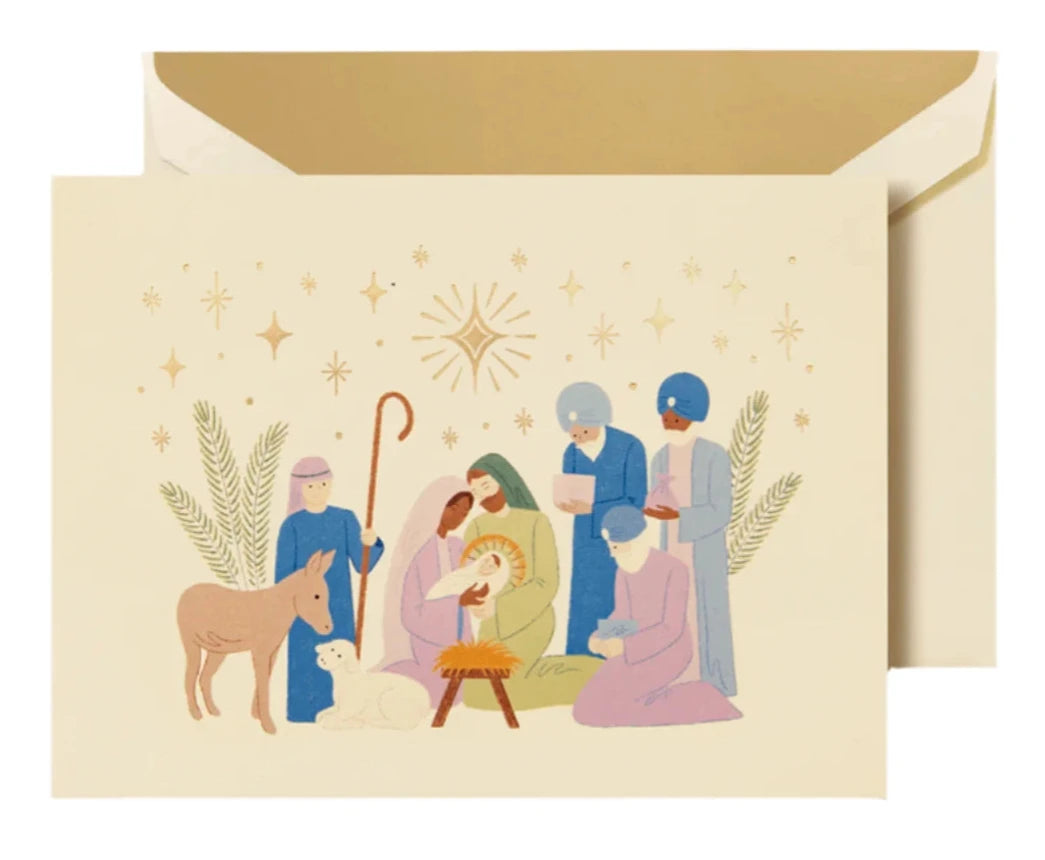 The Crane Nativity Christmas Card Set features a cream-colored card with a Nativity scene—Mary, Joseph, baby Jesus in a manger, wise men, shepherd, lamb, donkey, and stars—ideal for celebrating the holiday season.