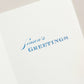 The Crane Silver Snowflake Card Set features elegant white cards with silver snowflakes and "Season's Greetings" printed in blue inside—perfect for celebrating the holiday season.