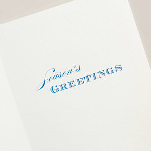 The Crane Silver Snowflake Card Set features elegant white cards with silver snowflakes and "Season's Greetings" printed in blue inside—perfect for celebrating the holiday season.