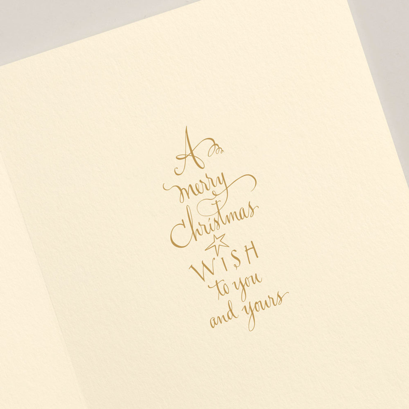 The Crane Penny Farthing Santa Card Set, crafted by Crane, features a vintage-style card adorned with elegant gold cursive text reading, "A merry Christmas wish to you and yours," beautifully capturing the timeless essence of the season.