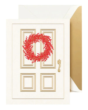 The Crane Red Berry Wreath Card Set features a holiday card with a white door, gold accents, and a red berry wreath, paired with a white envelope lined in gold.