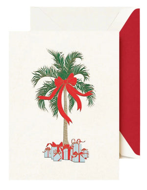 The Crane Christmas Palm Card Set features cards with a festive palm tree adorned with a red bow and gifts, paired with white envelopes lined in red—making them perfect for holiday greetings.