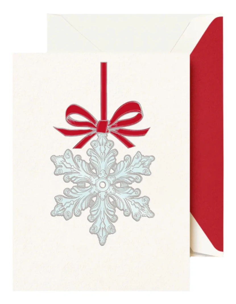 Celebrate the season with Crane’s Snowflake Ornament Card Set, featuring a silver snowflake and red bow on the card front, paired with a festive red and white envelope for a magical holiday touch.