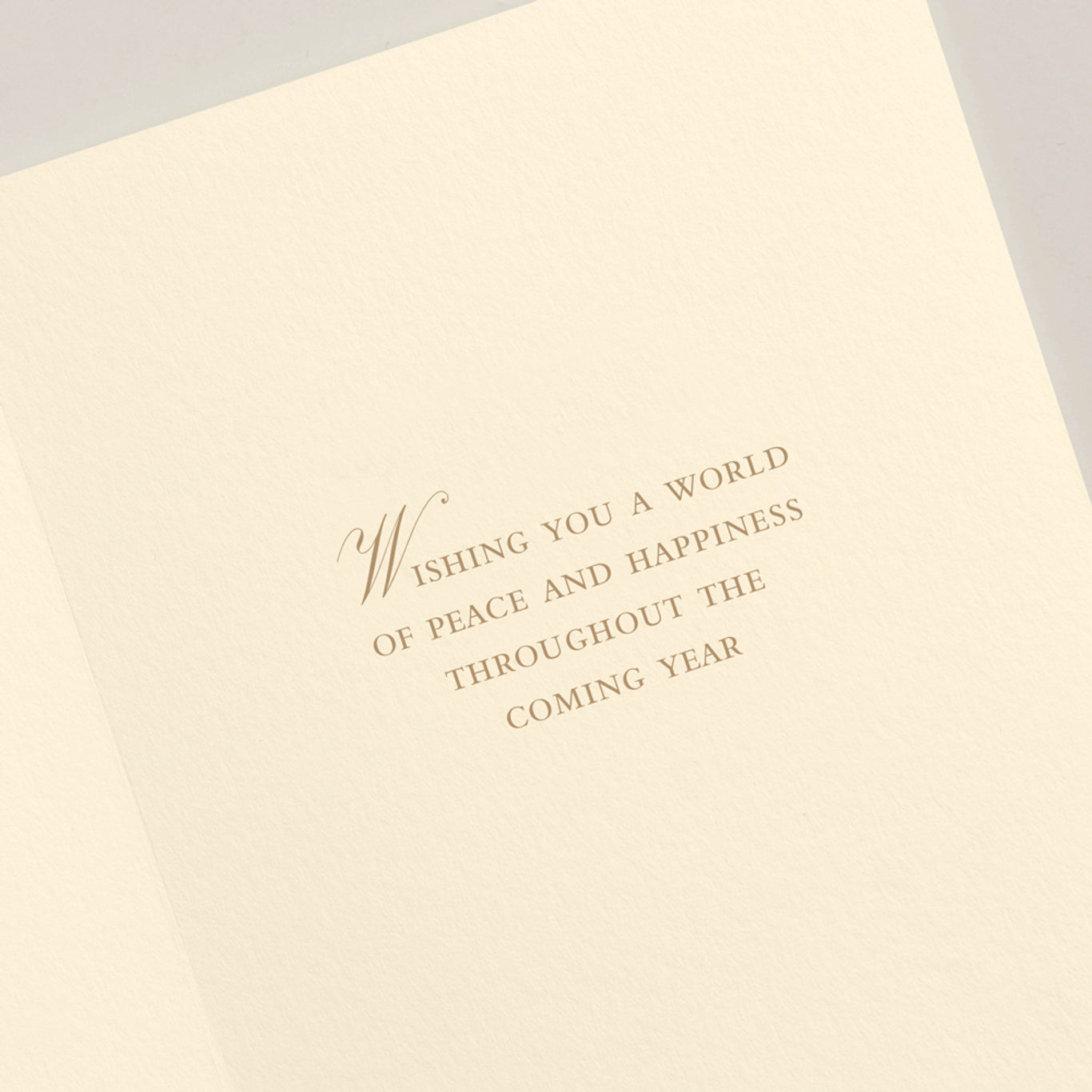 The Crane Faith Hope Peace Love Card Set features an open holiday card with "Wishing you a world of peace and happiness throughout the coming year" engraved in elegant brown serif font on cream-colored paper.