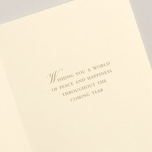 The Crane Faith Hope Peace Love Card Set features an open holiday card with "Wishing you a world of peace and happiness throughout the coming year" engraved in elegant brown serif font on cream-colored paper.