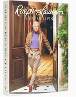 Book cover of “Ralph Lauren A Way of Living” by Rizzoli, a definitive lifestyle book, featuring a man in a leather jacket and scarf standing in a doorway adorned with decorative plants—a perfect introduction to the timeless elegance of Ralph Lauren home and interior design.