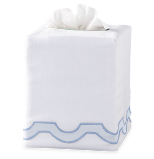 The Matouk Mirasol Tissue Box Cover Blue features white linen with a blue scalloped trim, adding an elegant touch to your space.