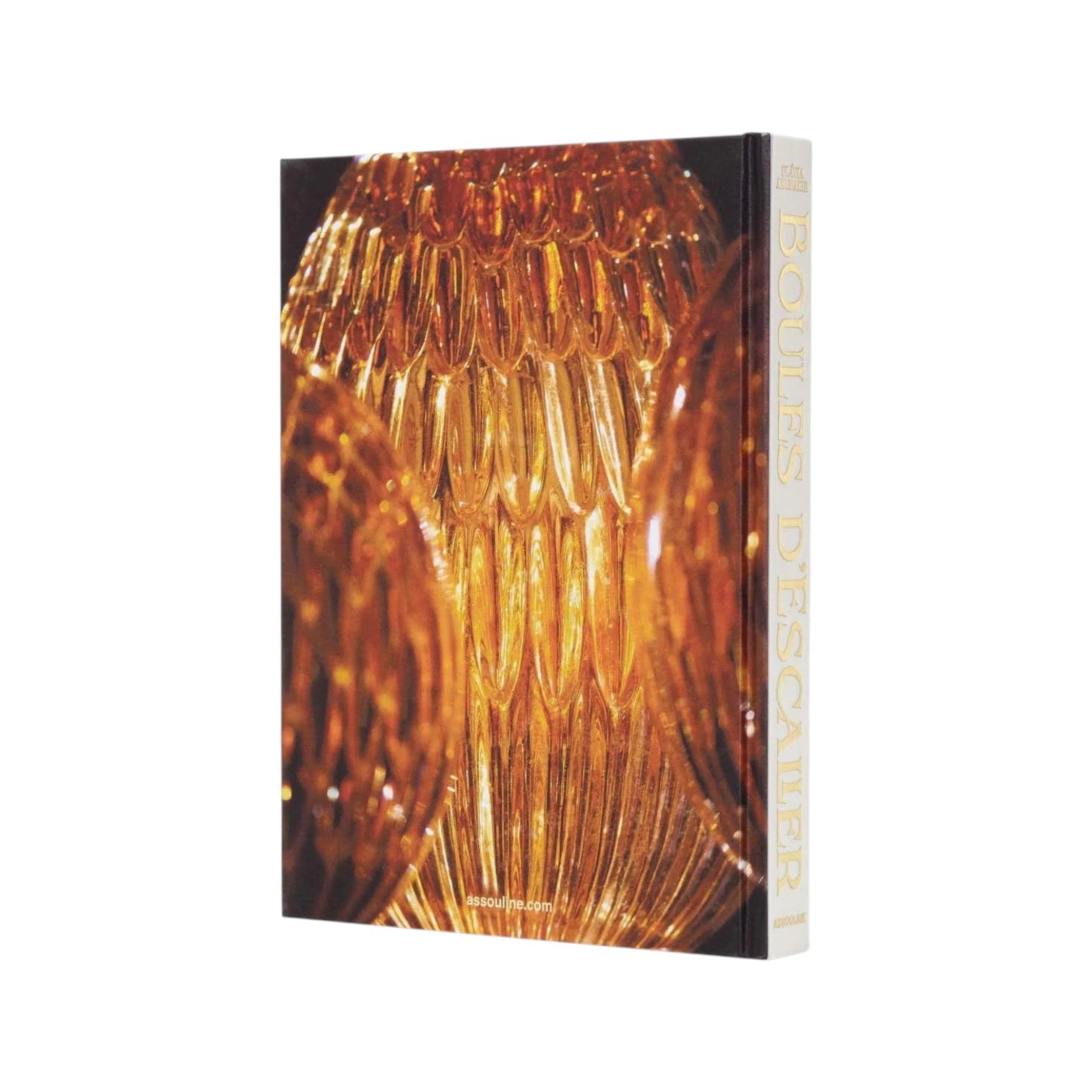 Assouline’s “Boules D'Escalier: The Flávia & Frank Abubakir Collection” features a cover with a close-up of golden glass staircase finials and the title along the spine.